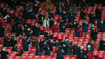 LONDON, ENGLAND - DECEMBER 13: Fans show their support prior to the Premier League match between Arsenal and Burnley at Emirates Stadium on December 13, 2020 in London, England. A limited number of spectators (2000) are welcomed back to stadiums to watch elite football across England. This was following easing of restrictions on spectators in tiers one and two areas only. (Photo by Catherine Ivill/Getty Images )