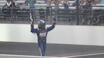 Jul 23, 2016; Indianapolis, IN, USA; NASCAR Xfinity driver Kyle Busch holds up the checkered flag after winning the Lilly Diabetes 250 at Indianapolis Motor Speedway. Mandatory Credit: Brian Spurlock-USA TODAY Sports