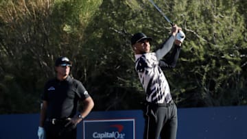 TUCSON, ARIZONA - NOVEMBER 27: Stephen Curry plays his shot from the ninth tee as Phil Mickelson looks on during Capital One's The Match: Champions For Change at Stone Canyon Golf Club on November 27, 2020 in Oro Valley, Arizona. (Photo by Cliff Hawkins/Getty Images for The Match)