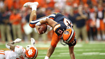 SYRACUSE, NEW YORK - SEPTEMBER 14: Tommy DeVito #13 of the Syracuse Orange trips during a game against the Clemson Tigers at the Carrier Dome on September 14, 2019 in Syracuse, New York. (Photo by Bryan M. Bennett/Getty Images)
