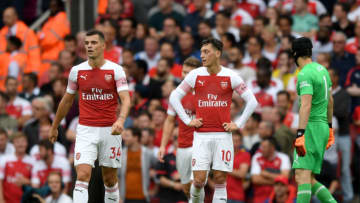 LONDON, ENGLAND - AUGUST 12: Granit Xhaka of Arsenal and Mesut Ozil of Arsenal look dejected after conceding a second goal during the Premier League match between Arsenal FC and Manchester City at Emirates Stadium on August 12, 2018 in London, United Kingdom. (Photo by Shaun Botterill/Getty Images)