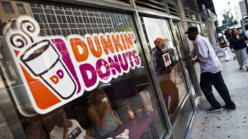 NEW YORK, NY - JULY 11: A customer enters a Dunkin' Donuts store in midtown Manhattan on July 11, 2011 in the New York City. Dunkin' Brands Group Inc., the parent of Dunkin' Donuts, plans to raise as much as $401 million by selling its initial public offering of 22.3 million shares, which are expected to fetch between $16 and $18. (Photo by Ramin Talaie/Getty Images)