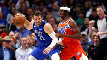 Luka Doncic #77 of the Dallas Mavericks protects the ball from Shai Gilgeous-Alexander #2 of the Oklahoma City Thunder Photo by Ron Jenkins/Getty Images)