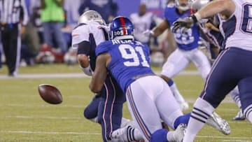 Nov 15, 2015; East Rutherford, NJ, USA; New York Giants defensive end Robert Ayers (91) sacks New England Patriots quarterback Tom Brady (12) and causes a fumble during the fourth quarter at MetLife Stadium. New England Patriots defeat the New York Giants 27-26. Mandatory Credit: Jim O
