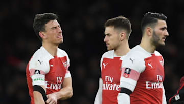 LONDON, ENGLAND - JANUARY 25: An injured Laurent Koscielny of Arsenal leaves the pitch as team mate Aaron Ramsey looks on during the FA Cup Fourth Round match between Arsenal and Manchester United at Emirates Stadium on January 25, 2019 in London, United Kingdom. (Photo by Mike Hewitt/Getty Images)