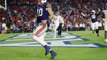 Auburn footballOct 30, 2021; Auburn, Alabama, USA; Auburn Tigers quarterback Bo Nix (10) scores a touchdown against the Mississippi Rebels during the second quarter at Jordan-Hare Stadium. Mandatory Credit: John Reed-USA TODAY Sports