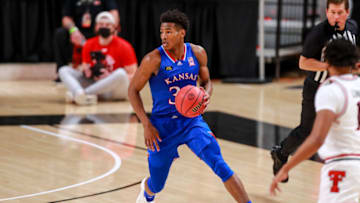 LUBBOCK, TEXAS - DECEMBER 17: Guard Ochai Agbaji #30 of the Kansas Jayhawks handles the ball during the first half of the college basketball game against the Texas Tech Red Raiders at United Supermarkets Arena on December 17, 2020 in Lubbock, Texas. (Photo by John E. Moore III/Getty Images)