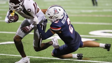 TUCSON, ARIZONA - SEPTEMBER 10: Cornerback Isaiah Rutherford #2 of the Arizona Wildcats tackles wide receiver Rara Thomas #0 of the Mississippi State Bulldogs during the NCAA football game at Arizona Stadium on September 10, 2022 in Tucson, Arizona. (Photo by Rebecca Noble/Getty Images)