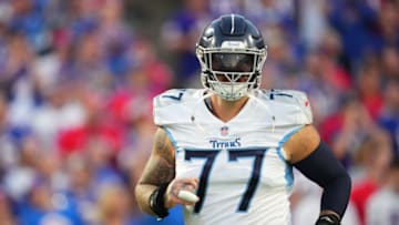 ORCHARD PARK, NY - SEPTEMBER 19: Taylor Lewan #77 of the Tennessee Titans runs onto the field against the Buffalo Bills at Highmark Stadium on September 19, 2022 in Orchard Park, New York. (Photo by Cooper Neill/Getty Images)