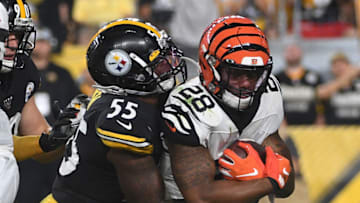 PITTSBURGH, PA - SEPTEMBER 30: Joe Mixon #28 of the Cincinnati Bengals is wrapped up for a tackle by Devin Bush #55 of the Pittsburgh Steelers in the first quarter during the game at Heinz Field on September 30, 2019 in Pittsburgh, Pennsylvania. (Photo by Justin Berl/Getty Images)