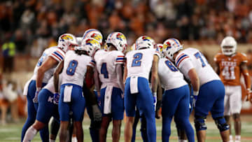 AUSTIN, TEXAS - NOVEMBER 13: The Kansas Jayhawks huddle in the second half against the Texas Longhorns at Darrell K Royal-Texas Memorial Stadium on November 13, 2021 in Austin, Texas. (Photo by Tim Warner/Getty Images)