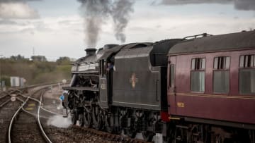 YEOVIL, ENGLAND - APRIL 26: A historic 'Black Five' steam locomotive hauls a ten-carriage train out Yeovil Junction near Yeovil on April 26, 2018 in Somerset, England. A Southern Railway 1920s 'Mogul' steam locomotive will help haul the special excursion main line passenger train between Yeovil, Dorchester and Weymouth for the first time in more than 50 years, following a successful test run earlier this month. Today's journey is part of the 'Great Britain XI' excursion train which started its nine-day journey from London's King's Cross station last week with a tour of England, Scotland and Wales, ending at London's Victoria station tomorrow. (Photo by Matt Cardy/Getty Images)