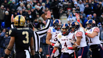 BALTIMORE, MD - DECEMBER 13: Wide receiver Jamir Tillman #4 of the Navy Midshipmen celebrates with teammates after catching a touchdown pass in the first half against the Army Black Knights at M&T Bank Stadium on December 13, 2014 in Baltimore, Maryland. Navy won 17-10. (Photo by Rob Carr/Getty Images)