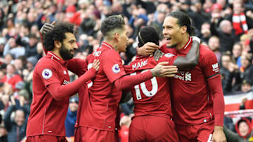 LIVERPOOL, ENGLAND - APRIL 14: Sadio Mane of Liverpool (10) celebrates after scoring his team's first goal with Virgil van Dijk, Roberto Firmino and Mohamed Salah during the Premier League match between Liverpool FC and Chelsea FC at Anfield on April 14, 2019 in Liverpool, United Kingdom. (Photo by Michael Regan/Getty Images)