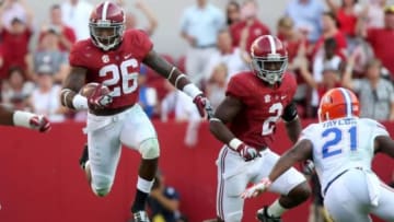 Sep 20, 2014; Tuscaloosa, AL, USA; Alabama Crimson Tide defensive back Landon Collins (26) returns an interception as Alabama Crimson Tide defensive back Tony Brown (2) blocks Florida Gators running back Kelvin Taylor (21) in the fourth quarter of their game at Bryant-Denny Stadium. Alabama won 42-21. Mandatory Credit: Jason Getz-USA TODAY Sports