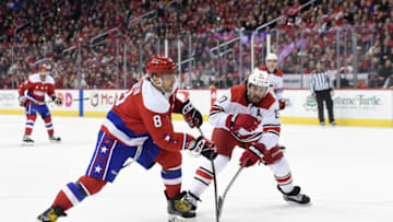 WASHINGTON, DC - DECEMBER 27: Alex Ovechkin #8 of the Washington Capitals skates with the puck against Justin Faulk #27 of the Carolina Hurricanes in the first period at Capital One Arena on December 27, 2018 in Washington, DC. (Photo by Patrick McDermott/NHLI via Getty Images)