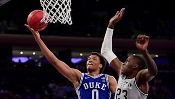 NEW YORK, NEW YORK - NOVEMBER 22: Wendell Moore Jr. #0 of the Duke Blue Devils goes in for a layup past Josh LeBlanc #23 of the Georgetown Hoyas during the second half of their game at Madison Square Garden on November 22, 2019 in New York City. (Photo by Emilee Chinn/Getty Images)