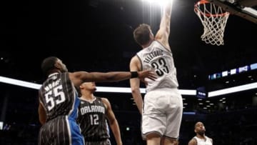 Apr 13, 2014; Brooklyn, NY, USA; Brooklyn Nets forward Mirza Teletovic (33) puts up a shot against Orlando Magic guard E Twaun Moore (55) and forward Tobias Harris (12) in the fourth quarter at Barclays Center. Nets win 97-88. Mandatory Credit: Nicole Sweet-USA TODAY Sports