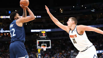 Karl-Anthony Towns of the Minnesota Timberwolves shoots the ball over Nikola Jokic of the Denver Nuggets. (Photo by C. Morgan Engel/Getty Images)