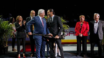 SUNRISE, FL - OCTOBER 13: Goaltender Roberto Luongo is presented with a gold and crystal stick by President of Hockey Operations and General Manager Dale Tallon during a celebration of playing in 1000th NHL game. Prior to the Florida Panthers hosting the Vancouver Canucks at the BB&T Center on October 13, 2018 in Sunrise, Florida. (Photo by Eliot J. Schechter/NHLI via Getty Images)