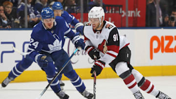 TORONTO, ON - FEBRUARY 11: Taylor Hall #91 of the Arizona Coyotes skates with the puck against Kasperi Kapanen #24 of the Toronto Maple Leafs during an NHL game at Scotiabank Arena on February 11, 2020 in Toronto, Ontario, Canada. The Maple Leafs defeated the Coyotes 3-2 in overtime. (Photo by Claus Andersen/Getty Images)