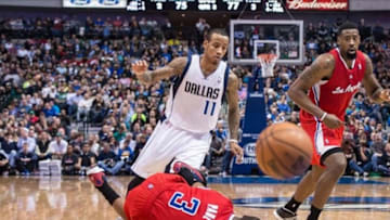 Jan 3, 2014; Dallas, TX, USA; Los Angeles Clippers point guard Chris Paul (3) falls to the court while dribbling past Dallas Mavericks shooting guard Monta Ellis (11) during the second half at the American Airlines Center. Paul sprained his right shoulder and did not return to the game. The Clippers defeated the Mavericks 119-112. Mandatory Credit: Jerome Miron-USA TODAY Sports