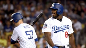 LOS ANGELES, CA - AUGUST 14: Yasiel Puig #66 of the Los Angeles Dodgers reacts to his strikeout in front of Alex Wood #57 during the second inning against the San Francisco Giants at Dodger Stadium on August 14, 2018 in Los Angeles, California. (Photo by Harry How/Getty Images)