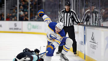 SEATTLE, WASHINGTON - OCTOBER 25: Jared McCann #19 of the Seattle Kraken and Tage Thompson #72 of the Buffalo Sabres play the puck during the third period at Climate Pledge Arena on October 25, 2022 in Seattle, Washington. (Photo by Steph Chambers/Getty Images)