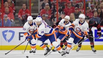 RALEIGH, NORTH CAROLINA - MAY 03: Tom Kuhnhackl #14 of the New York Islanders pushed the puck up the ice against the Carolina Hurricanes in the second period of Game Four of the Eastern Conference Second Round during the 2019 NHL Stanley Cup Playoffs at PNC Arena on May 03, 2019 in Raleigh, North Carolina. (Photo by Grant Halverson/Getty Images)