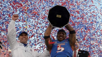 Dec 22, 2012; Las Vegas, NV, USA; Boise State Broncos coach Chris Petersen (left) and cornerback Jamar Taylor (5) hoist the 2012 Maaco Bowl trophy after the game against the Washington Huskies at Sam Boyd Stadium. Boise State defeated Washington 28-26. Mandatory Credit: Kirby Lee/Image of Sport-USA TODAY Sports