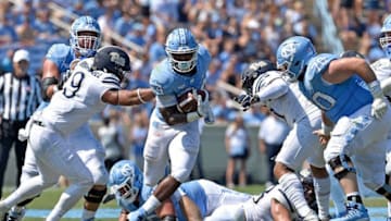 CHAPEL HILL, NC - SEPTEMBER 22: Antonio Williams #24 of the North Carolina Tar Heels breaks through the Pittsburgh Panthers defensive line during their game at Kenan Stadium on September 22, 2018 in Chapel Hill, North Carolina. (Photo by Grant Halverson/Getty Images)