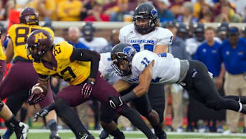 Aug 28, 2014; Minneapolis, MN, USA; Minnesota Gophers running back David Cobb (27) gets tackled in the first quarter by Eastern Illinois Panthers linebacker Kamu Grugier-Hill (32) at TCF Bank Stadium. Mandatory Credit: Brad Rempel-USA TODAY Sports