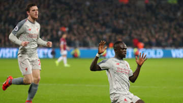 LONDON, ENGLAND - FEBRUARY 04: Sadio Mane of Liverpool celebrates with teammate Andy Robertson of Liverpool after scoring their team's first goal during the Premier League match between West Ham United and Liverpool FC at London Stadium on February 04, 2019 in London, United Kingdom. (Photo by Catherine Ivill/Getty Images)