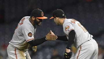 ANAHEIM, CA - JULY 25: Outfielder Stevie Wilkerson #12 of the Baltimore Orioles, who came in from center field to close the game against Los Angeles Angels of Anaheim in the 16th inning, is congratulated by Jonathan Villar #2 after outlasting the Angels of Anaheim, 10-8, at Angel Stadium of Anaheim on July 25, 2019 in Anaheim, California. Wilkerson became the first position player in Major League Baseball history to record a pitching save. (Photo by Kevork Djansezian/Getty Images)