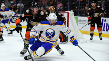 Oct 28, 2021; Anaheim, California, USA; Buffalo Sabres left wing Vinnie Hinostroza (29) moves the puck against Anaheim Ducks defenseman Simon Benoit (86) during the first period at Honda Center. Mandatory Credit: Gary A. Vasquez-USA TODAY Sports