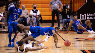 Jan 12, 2021; Stillwater, Oklahoma, USA; Kansas Jayhawks guard Bryce Thompson (24) and Oklahoma State Cowboys guard Avery Anderson III (0) fight for a loose ball during the second half at Gallagher-Iba Arena. Mandatory Credit: Rob Ferguson-USA TODAY Sports