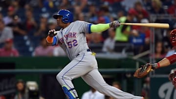 Sep 12, 2016; Washington, DC, USA; New York Mets center fielder Yoenis Cespedes (52) hits a sacrifice fly scoring baseman Jose Reyes (not pictured) during the first inning against the Washington Nationals at Nationals Park. Mandatory Credit: Tommy Gilligan-USA TODAY Sports