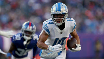 EAST RUTHERFORD, NEW JERSEY - NOVEMBER 20: Amon-Ra St. Brown #14 of the Detroit Lions carries the ball against the New York Giants during the first half at MetLife Stadium on November 20, 2022 in East Rutherford, New Jersey. (Photo by Jamie Squire/Getty Images)