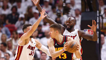 Max Strus #31 and Dewayne Dedmon #21 of the Miami Heat defend Bogdan Bogdanovic #13 of the Atlanta Hawks(Photo by Michael Reaves/Getty Images)