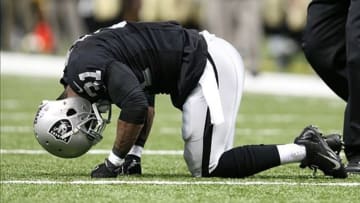 Aug 16, 2013; New Orleans, LA, USA; Oakland Raiders cornerback Tracy Porter bends over on the field before being helped off the field for an injury in the first half against the New Orleans Saints at the Mercedes-Benz Superdome. Mandatory Credit: Crystal LoGiudice-USA TODAY Sports