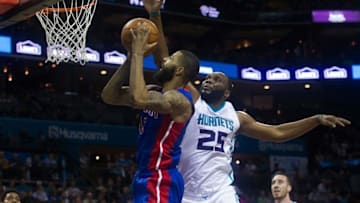 Mar 11, 2016; Charlotte, NC, USA; Detroit Pistons forward Marcus Morris (13) goes up for a shot against Charlotte Hornets center Al Jeffereson (25) in the first half at Time Warner Cable Arena. Mandatory Credit: Jeremy Brevard-USA TODAY Sports