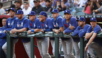 PHOENIX, ARIZONA - JUNE 24: Pitcher Hyun-Jin Ryu #99 (top right) of the Los Angeles Dodgers watches from the dugout with teammates during the first inning of the MLB game against the Arizona Diamondbacks at Chase Field on June 24, 2019 in Phoenix, Arizona. (Photo by Christian Petersen/Getty Images)