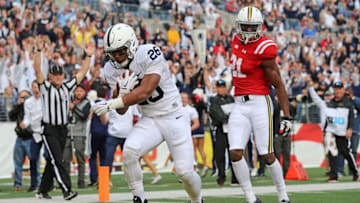 Oct 24, 2015; Baltimore, MD, USA; Penn State Nittany Lions running back Saquon Barkley (26) runs for a touchdown past Maryland Terrapins defensive back Sean Davis (21) at M&T Bank Stadium. Mandatory Credit: Mitch Stringer-USA TODAY Sports
