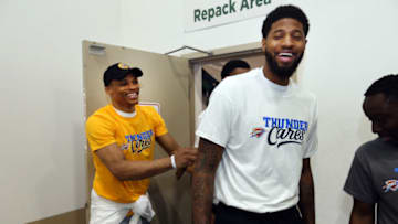 OKLAHOMA CITY, OK - MARCH 15: Oklahoma City Thunder players Russell Westbrook and Paul George volunteer with Thunder players, coaches and staff on March 15, 2018 at the Regional Food Bank of Oklahoma in Oklahoma City, Oklahoma. The Food Bank is providing enough food to feed more than 126,000 hungry Oklahomans every week. This years Thunder Day of Service will help the Food Bank fulfill its mission of Fighting HungerFeeding Hope. NOTE TO USER: User expressly acknowledges and agrees that, by downloading and or using this Photograph, user is consenting to the terms and conditions of the Getty Images License Agreement. Mandatory Copyright Notice: Copyright 2018 NBAE (Photo by Layne Murdoch/NBAE via Getty Images)