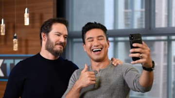 UNIVERSAL CITY, CALIFORNIA - JANUARY 16: Mark-Paul Gosselaar and Mario Lopez take a selfie together at "Extra" at Universal Studios Hollywood on January 16, 2019 in Universal City, California. (Photo by Noel Vasquez/Getty Images)