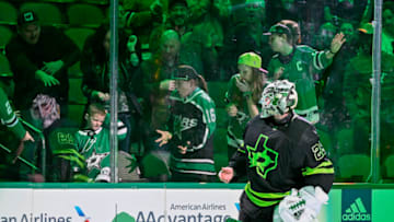 Jan 21, 2023; Dallas, Texas, USA; Dallas Stars goaltender Jake Oettinger (29) throws a puck to the Stars fans after he is named the number two star in the victory over the Arizona Coyotes at the American Airlines Center. Mandatory Credit: Jerome Miron-USA TODAY Sports