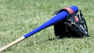 Apr 16, 2016; Boston, MA, USA; The glove and bat of Toronto Blue Jays first base coach Tim Leiper (34) rests on the grass prior to a game against the Boston Red Sox at Fenway Park. Mandatory Credit: Bob DeChiara-USA TODAY Sports
