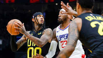 Oct 10, 2023; Seattle, Washington, USA; Utah Jazz guard Jordan Clarkson (00) rises to attempt a shot against LA Clippers forward Robert Covington (23) during the third quarter at Climate Pledge Arena. Mandatory Credit: Joe Nicholson-USA TODAY Sports
