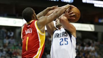 Oct 7, 2014; Dallas, TX, USA; Dallas Mavericks forward Chandler Parsons (25) is fouled on the shot by Houston Rockets forward Trevor Ariza (1) at American Airlines Center. Mandatory Credit: Matthew Emmons-USA TODAY Sports