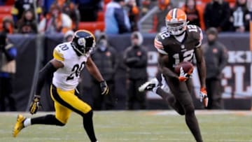 Nov 24, 2013; Cleveland, OH, USA; Cleveland Browns wide receiver Josh Gordon (12) runs the ball after a catch as Pittsburgh Steelers strong safety Will Allen (20) defends during the fourth quarter at FirstEnergy Stadium. The Steelers beat the Browns 27-11. Mandatory Credit: Ken Blaze-USA TODAY Sports